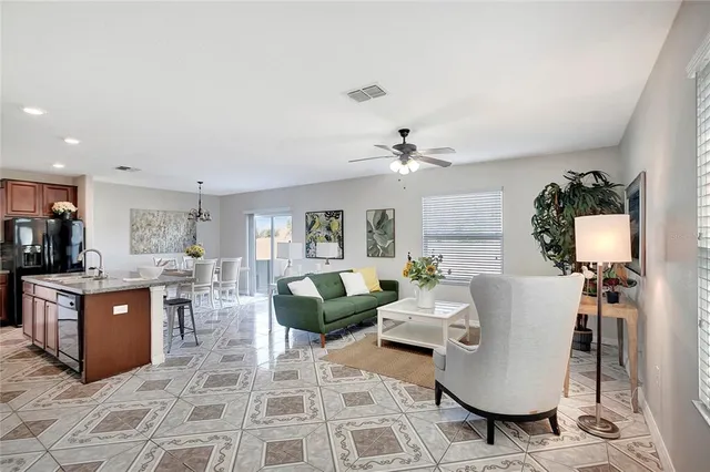 a living room with furniture or couch and a potted plant