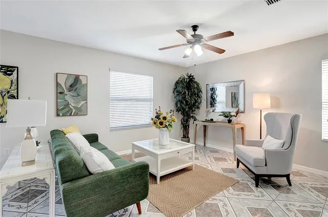 a living room with furniture and a dining table