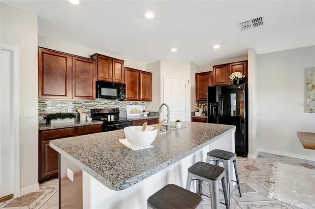 a dining room with furniture a chandelier and window