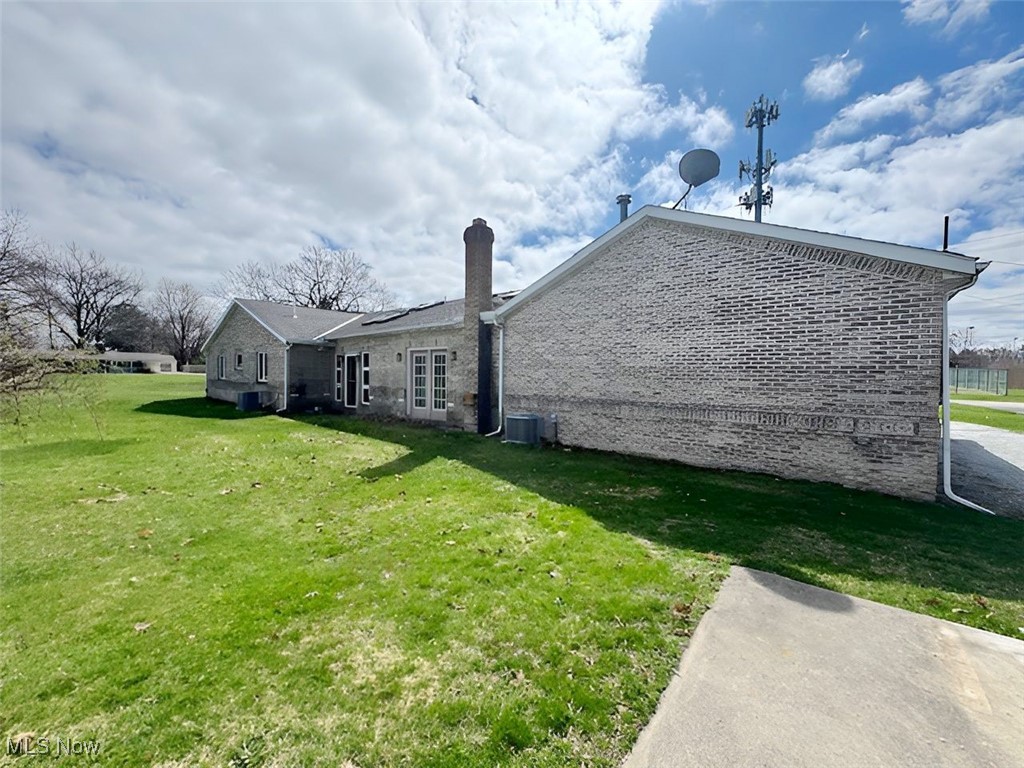 6224 Reynolds Road Mentor, OH 44060 - Photo 28 of 29 Back of property featuring a lawn, brick siding, and a chimney
