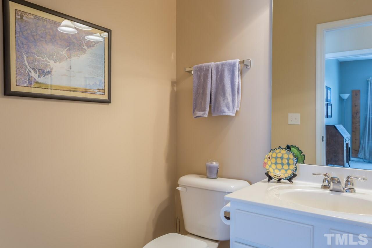 5331 Shaker Heights Lane Raleigh, NC 27613 - Photo 14 of 25 a bathroom with a toilet a sink and mirror