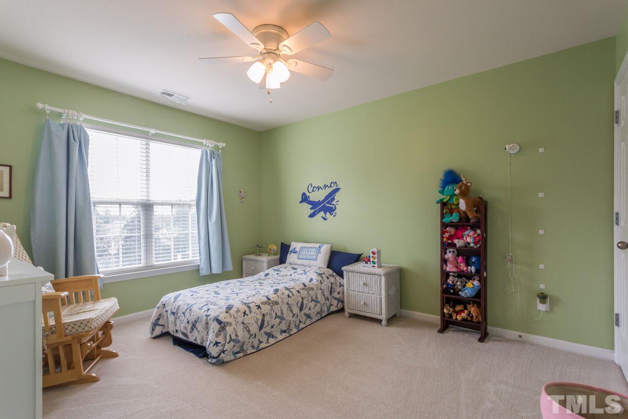 5331 Shaker Heights Lane Raleigh, NC 27613 - Photo 18 of 25 a bedroom with a bed and a window