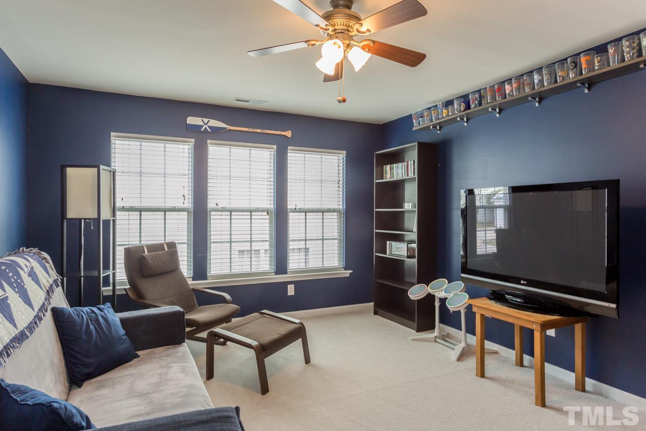 5331 Shaker Heights Lane Raleigh, NC 27613 - Photo 20 of 25 a living room with furniture and a flat screen tv