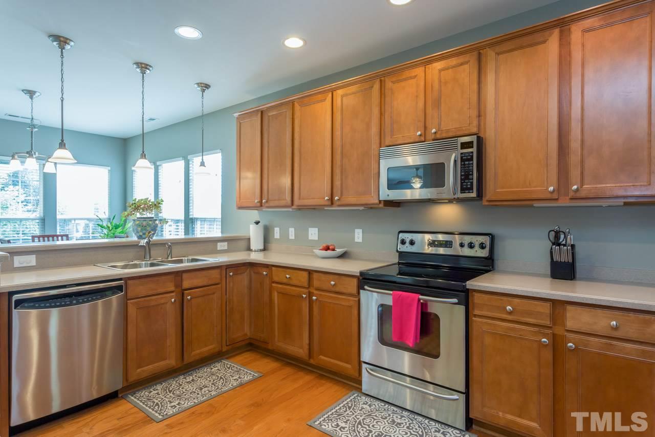 5331 Shaker Heights Lane Raleigh, NC 27613 - Photo 6 of 25 a kitchen with stainless steel appliances granite countertop a stove a sink and a microwave