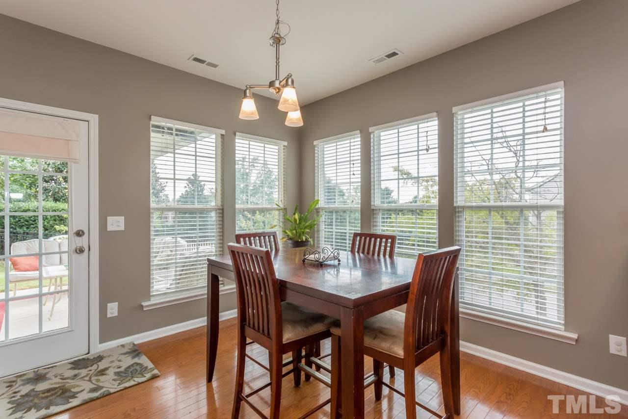 5331 Shaker Heights Lane Raleigh, NC 27613 - Photo 8 of 25 a view of a dining room with furniture wooden floor and chandelier