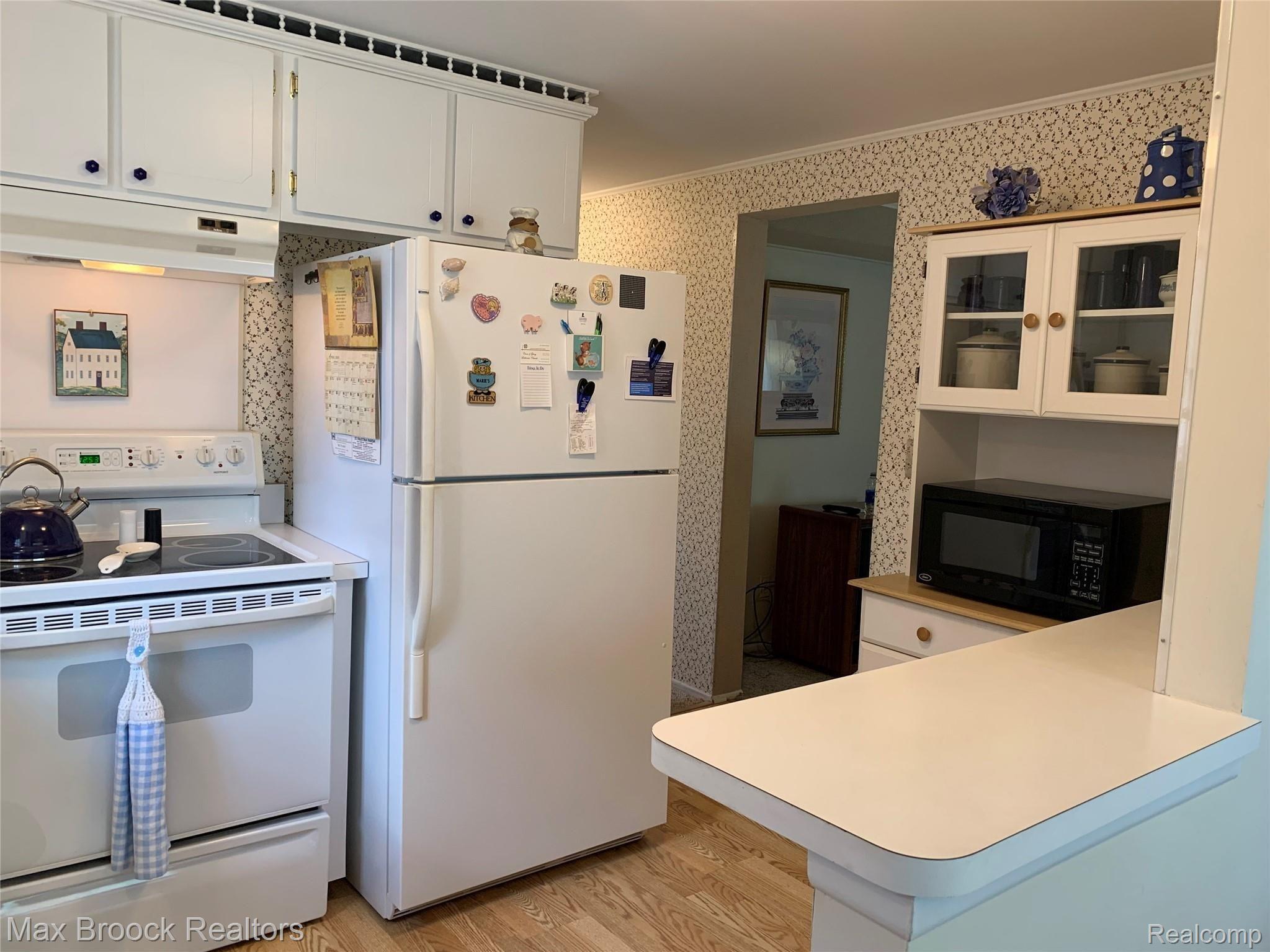 Functional kitchen includinig stove and refrigerator!  As you can see a breakfast bar for extra counter space and quick meals.  Generous storage cabinets as well.