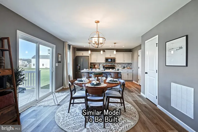 a dining room with furniture a chandelier and wooden floor