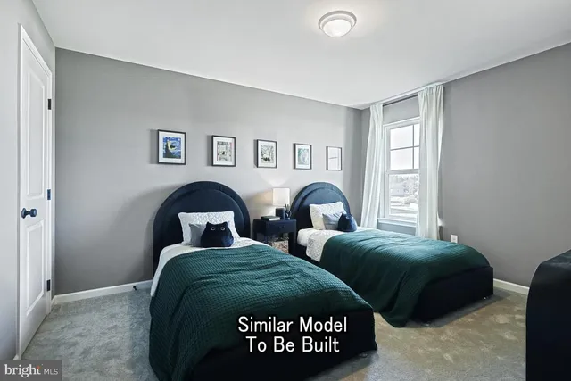 a bedroom with two beds and a window