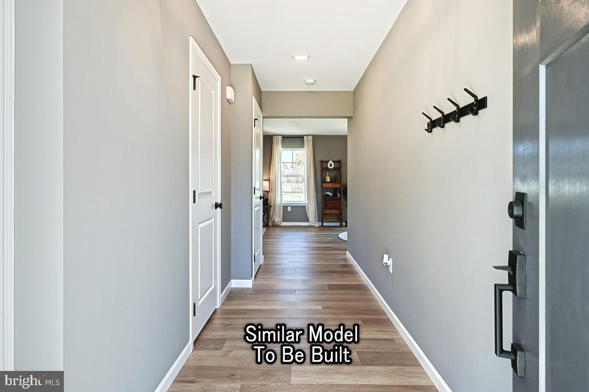 White Oak Plan At Hills Spring Grove, PA 17362 - Photo 8 of 42 a view of a hallway with wooden floor and a hallway
