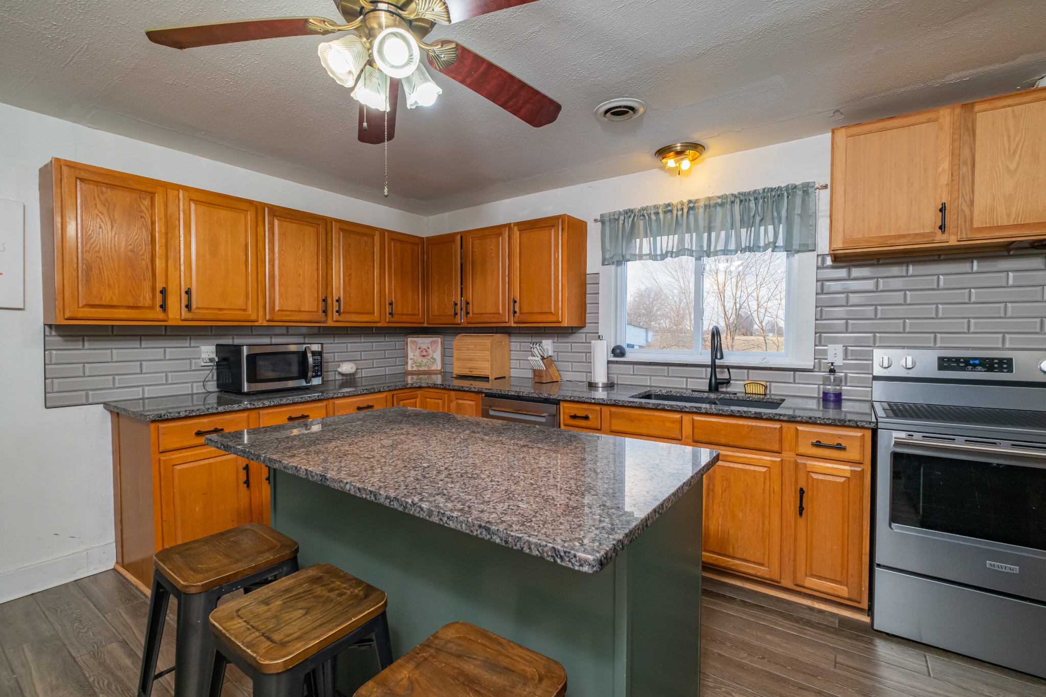 3324 Fredonia Road Manchester, TN 37355 - Photo 21 of 42 a kitchen with stainless steel appliances granite countertop a sink a stove and a microwave