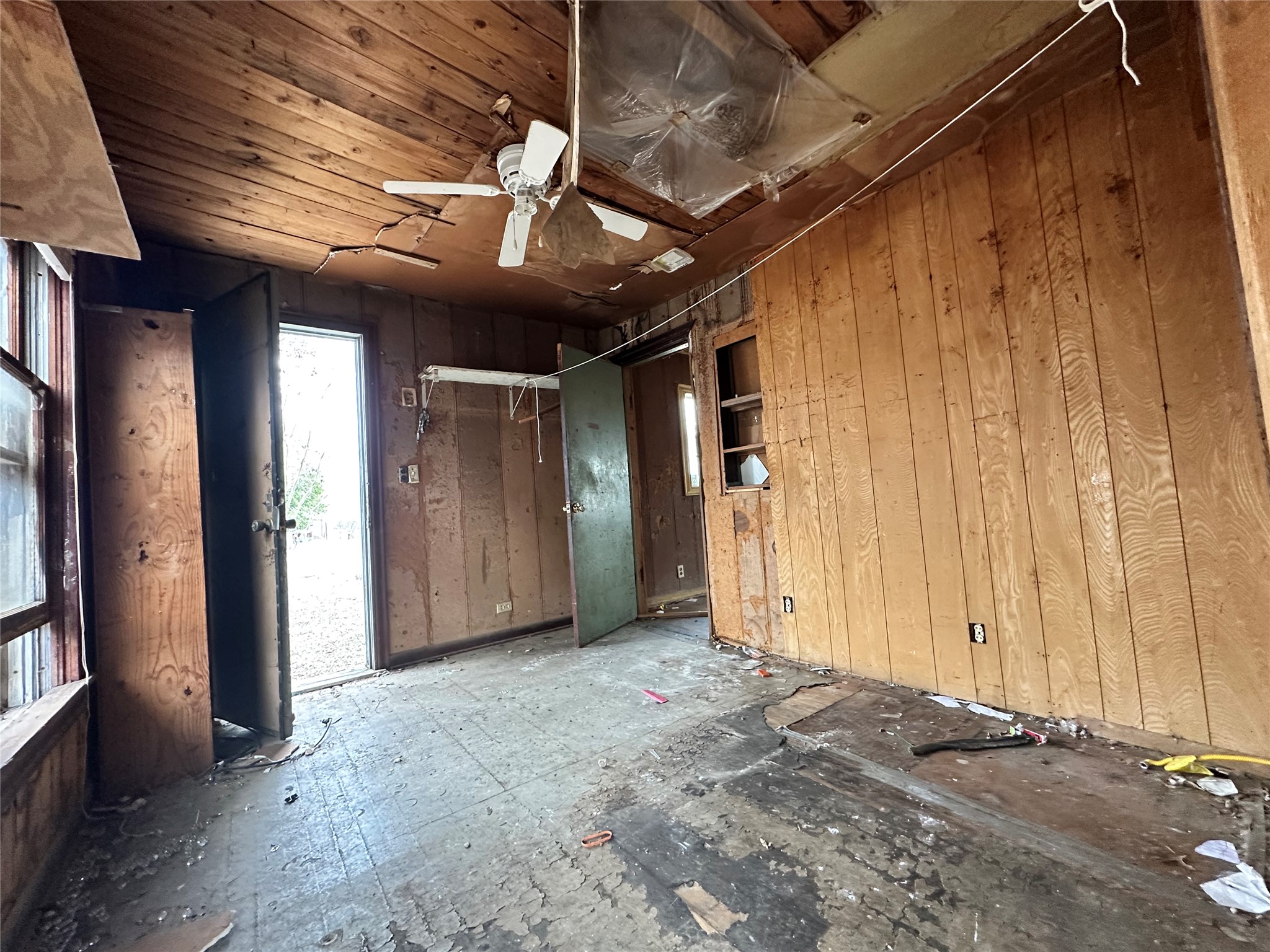 408 West Allen Street Kyle, TX 78640 - Photo 7 of 20 Spare room with a ceiling fan and wood walls