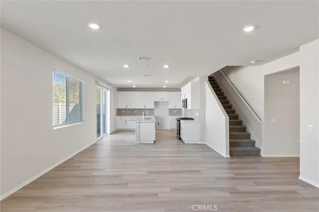 a view of kitchen and hall with wooden floor