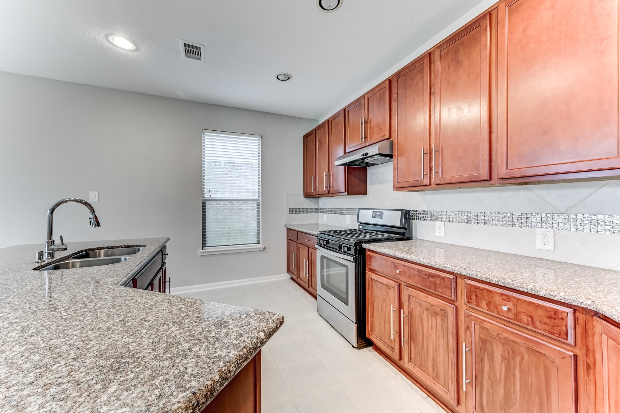 4706 Mint Trail Houston, TX 77066 - Photo 16 of 43 a kitchen with stainless steel appliances granite countertop a sink a stove and a refrigerator
