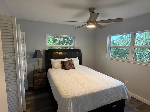 a bedroom with a bed and a large window