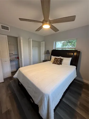 a large bed sitting in a bedroom next to a window
