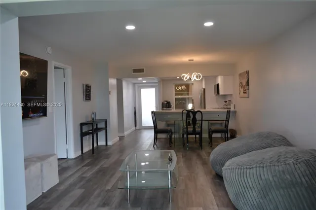 a view of a a dining room with furniture and wooden floor