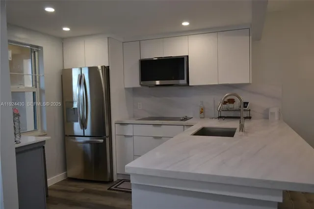 a kitchen with a refrigerator sink and microwave