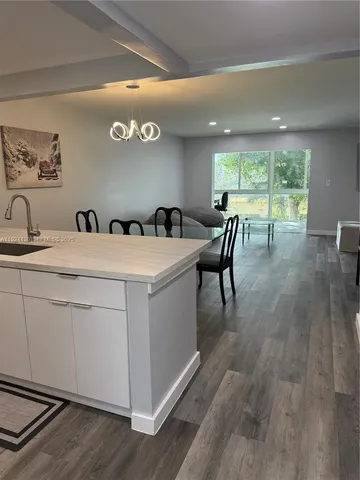 a view of living room with furniture and wooden floor