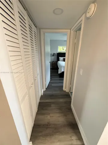 a view of a hallway with a livingroom and a hallway