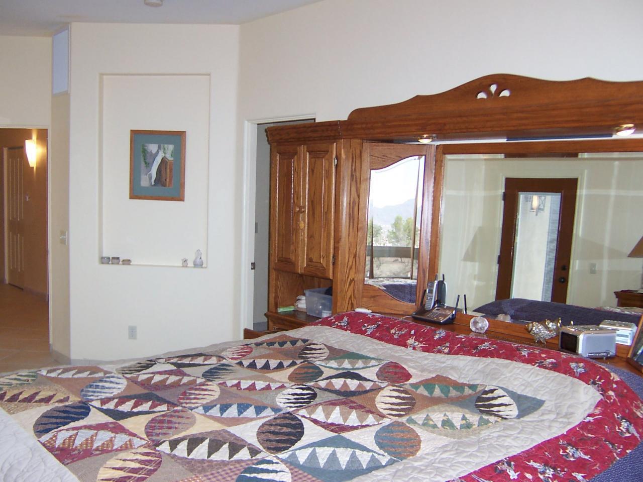 530 Ruth Lane Rio Rico, AZ 85648 - Photo 18 of 36 a bed sitting in a bedroom next to a window