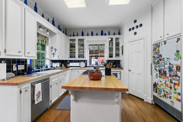a kitchen with stainless steel appliances a sink a stove and a refrigerator