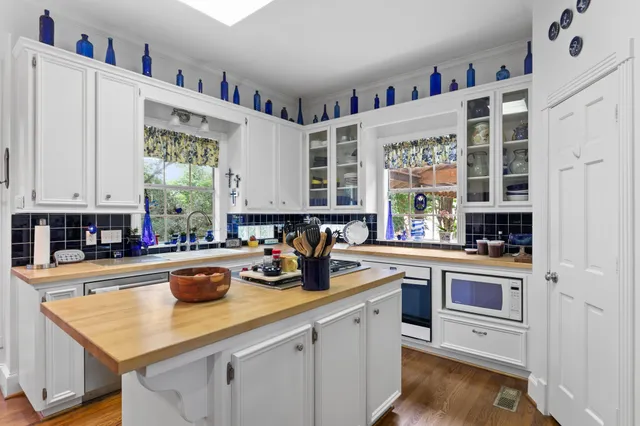 a kitchen with stainless steel appliances a sink a stove and a refrigerator