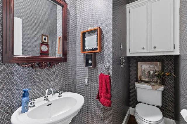 a bathroom with a toilet a sink and a mirror