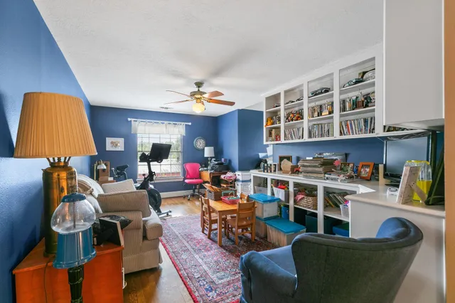 a living room with furniture and a chandelier