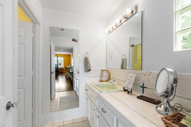 a spacious bathroom with a double vanity sink and a mirror