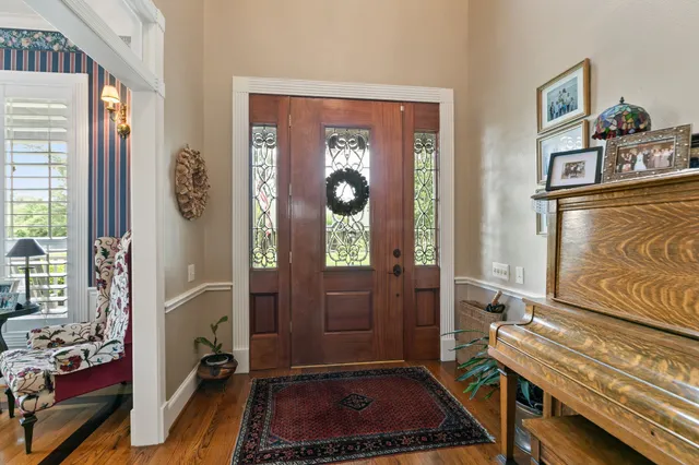 a room with painting on the wall and a window