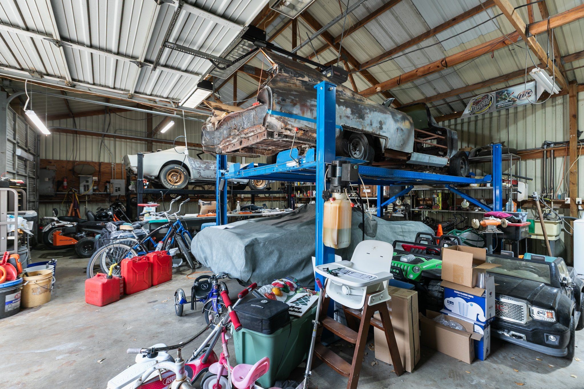 6710 Spring Cypress Road Spring, TX 77379 - Photo 35 of 48 2 lifts inside of workshop.