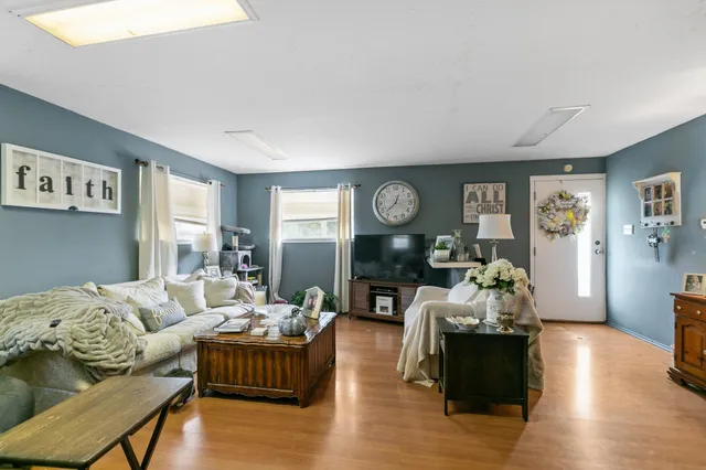 a living room with furniture and a mirror
