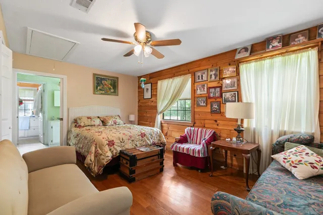 a bedroom with bed couch and window