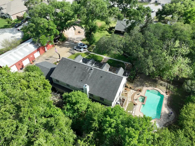 an aerial view of a house with a yard