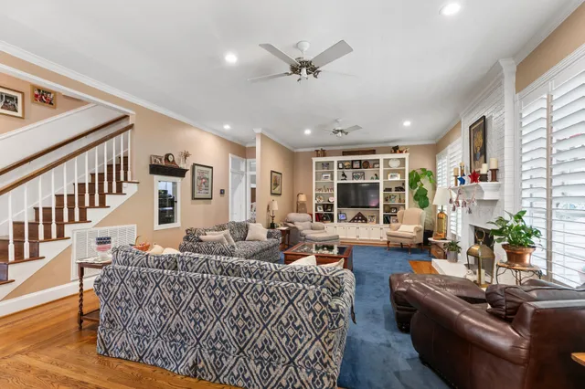 a living room with furniture fireplace and a large window