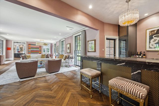 a living room with couches a dining table and chairs with wooden floor