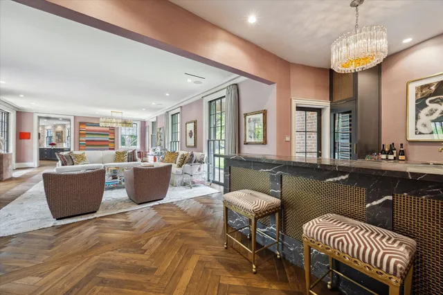 a living room with couches a dining table and chairs with wooden floor