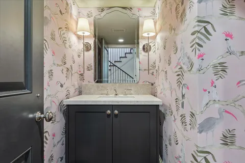 a bathroom with a sink and mirror with painted walls