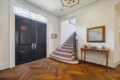 a view of a livingroom with wooden floor and stairs