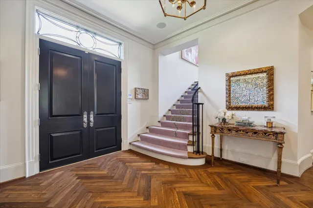 a view of a livingroom with wooden floor and stairs
