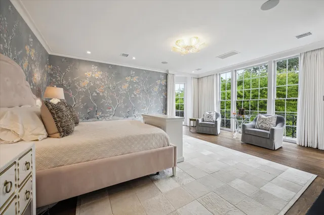 a bedroom with a bed and glass walk in closet