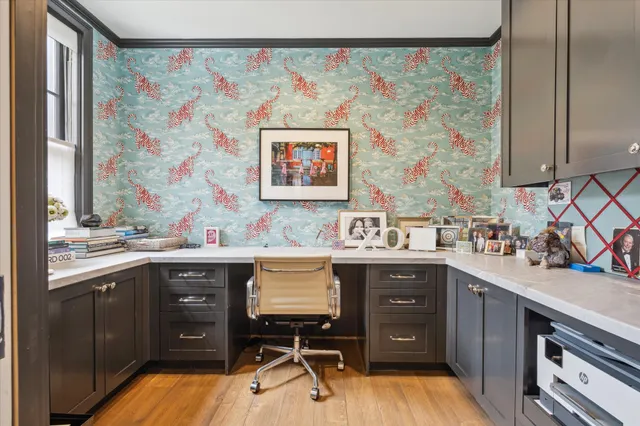 a view of a kitchen with workspace and wooden floor