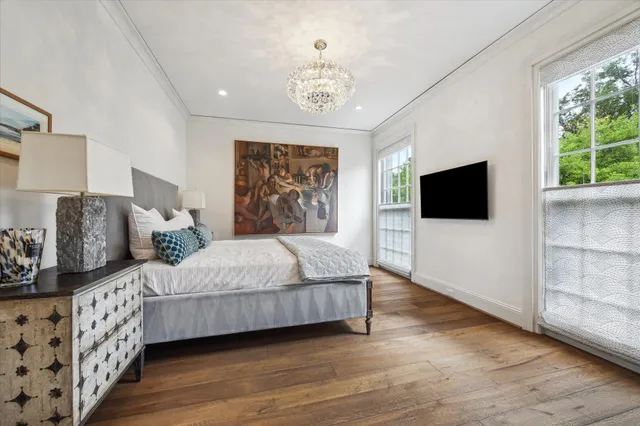 a bedroom with bed tv and window