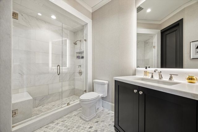 a bathroom with a sink a toilet and shower