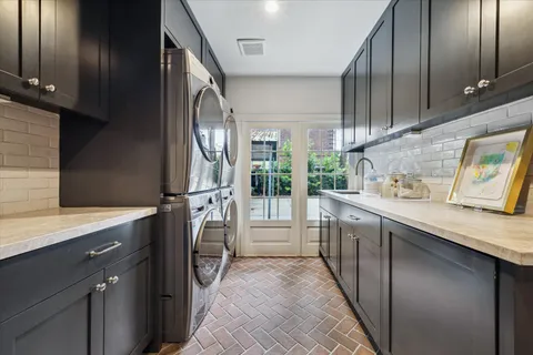 a kitchen with a sink stove and cabinets