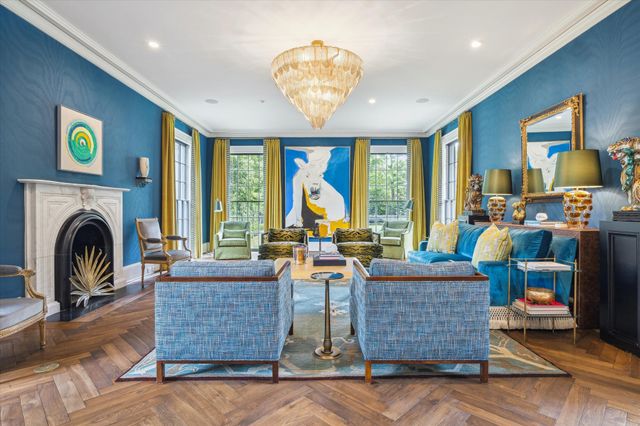 a living room with fireplace furniture and a large window
