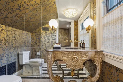 a bathroom with a toilet sink and mirror