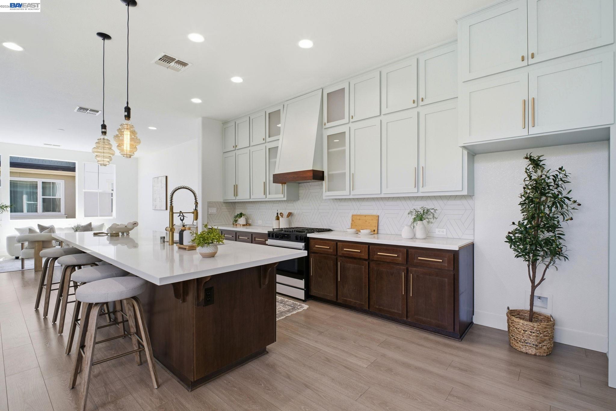 37784 Taro Terrace Newark, CA 94560 - Photo 2 of 20 a kitchen with stainless steel appliances granite countertop a sink a stove and a wooden floors