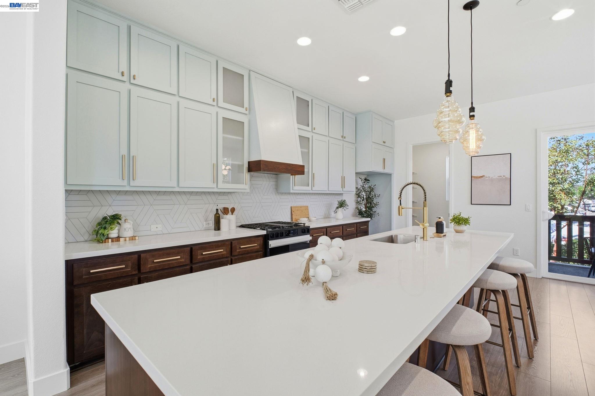 37784 Taro Terrace Newark, CA 94560 - Photo 3 of 20 a kitchen with stainless steel appliances a white table chairs and a refrigerator
