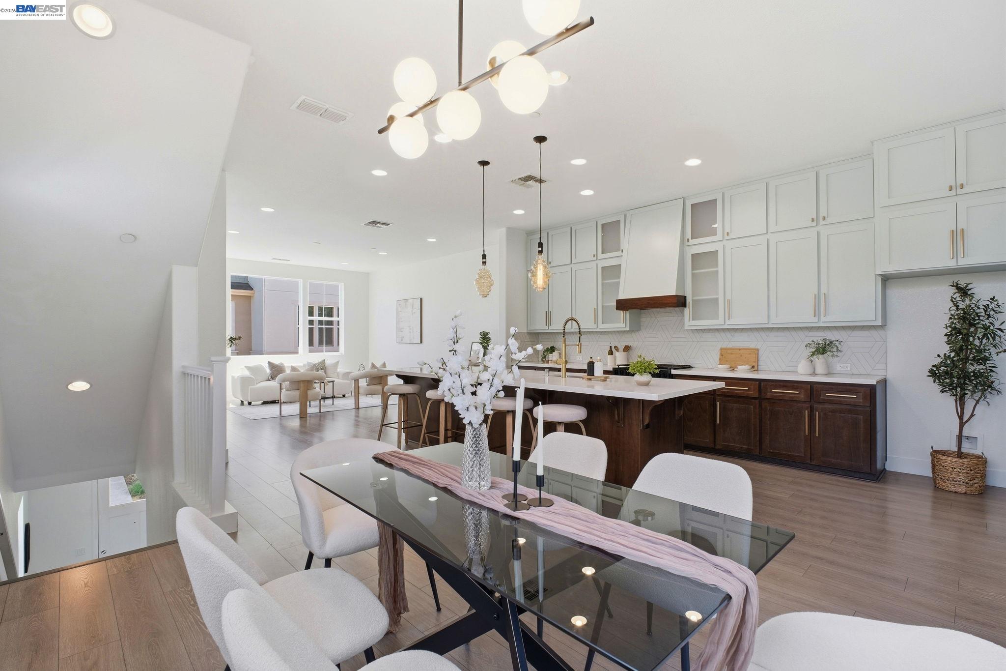 37784 Taro Terrace Newark, CA 94560 - Photo 8 of 20 a open dining room with stainless steel appliances kitchen island granite countertop a dining table chairs and a refrigerator